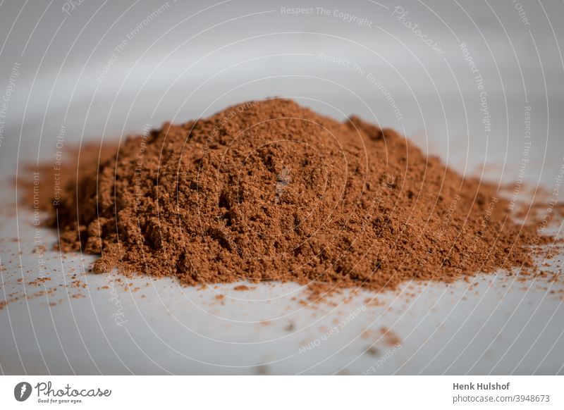 Ground nutmeg in a heap aroma aromatic background brown closeup cuisine culinary delicious dried dry flavor food healthy herb ingredient isolated macro muscat