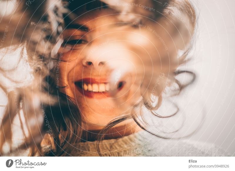Woman with long hair looks into camera bent over and smiles Smiling Selfie long hairs Laughter Good mood Joy look in leaning over Authentic Happiness