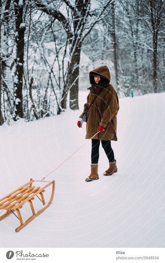 A woman with a sledge in the snow in winter Winter Snow Sleigh Woman Cold snowy Nature Forest Coat Brown Hooded (clothing) wood sledges Winter's day
