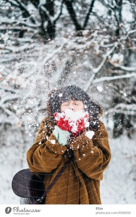 Woman blowing snow in winter Snow Winter Joy Snowscape snowy Nature out Cold White Winter mood Winter forest Winter's day Gloves Coat youthful frisky