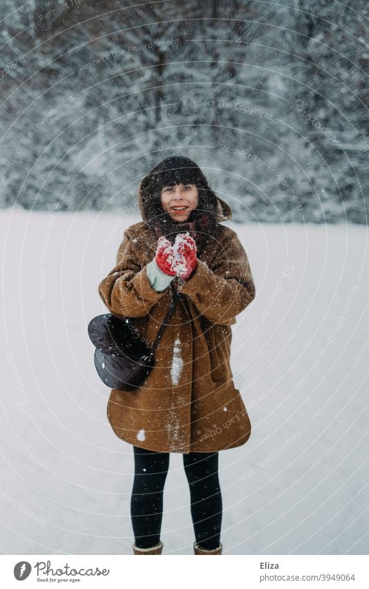 A woman in the snow Woman Snow Snowball Winter Funny Joy Dark-haired Human being White winter landscape Landscape out Nature Snowfall Winter's day Winter mood