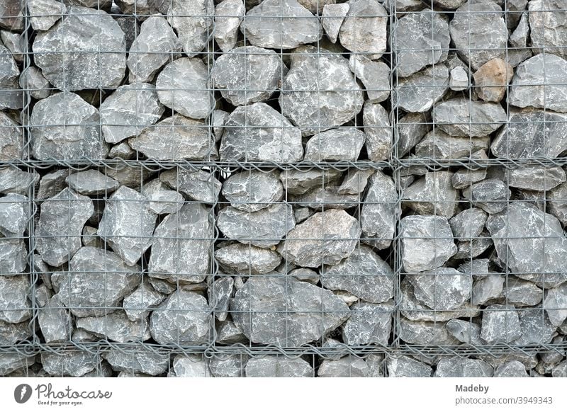Gabion made of wire with natural stone in grey as a decorative fence in the garden Fence Stone Natural stone Gray Nature Garden Gardening Architecture