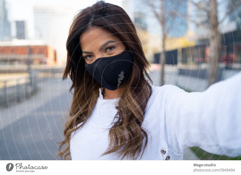 Young woman taking selfies outdoors. young urban face mask portrait lifestyle travel street brunette vacation tourist modern picture photographing posing