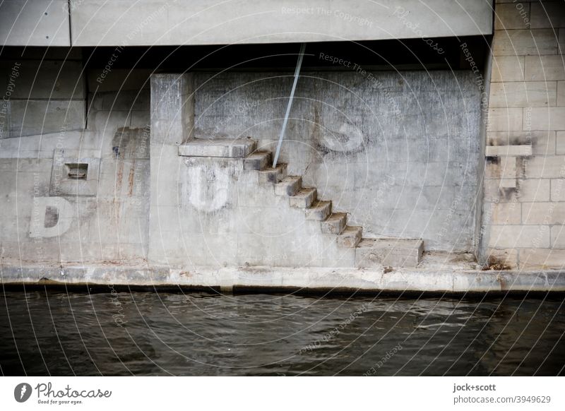 DUST and a staircase to nowhere Landwehrkanal Kreuzberg Berlin Architecture Channel Water Gray Capital letter Street art Foundations Manmade structures iron rod