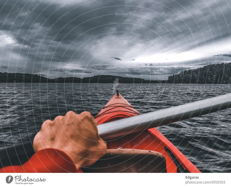 Man hand kayaking in a river, stormy day Kayak kayaker Kayaks Hand Adventure Travel Water Storm Clouds River Lake Red Vacation & Travel canoe Canoe trip