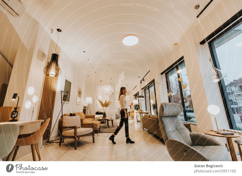 Young woman walking through livingroom home house interior female young indoors person comfortable pretty lifestyle floor caucasian inside modern furniture