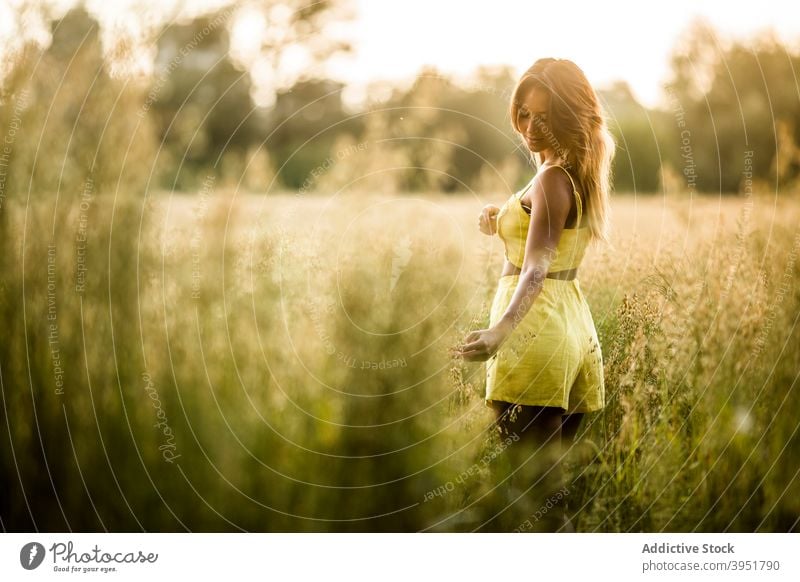 Woman standing in field in summer woman tranquil carefree touch grass park meadow female salburua vitoria gasteiz spain nature weekend calm harmony outfit