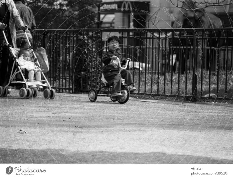 Tricycle in the Jardin des Plantes Paris Child Park Man Black & white photo Asia