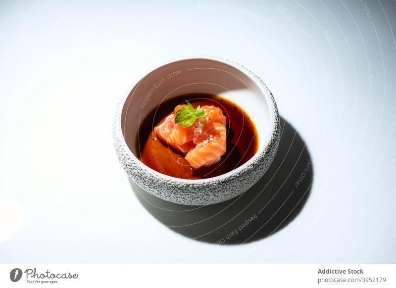 Bowl with tasty salmon with soy sauce served on white table bowl food meal fish sashimi asian food gourmet cuisine delicious raw nutrition dinner fresh