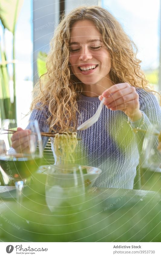 Smiling woman with bowl of ramen eat asian food delicious meal tasty yummy enjoy dish tradition young female blond happy cheerful smile restaurant lifestyle
