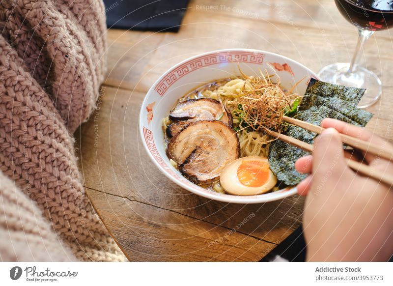 Woman eating traditional oriental ramen asian food noodle delicious bowl chopstick dish female pork egg meal tasty meat yummy woman cuisine lunch palatable