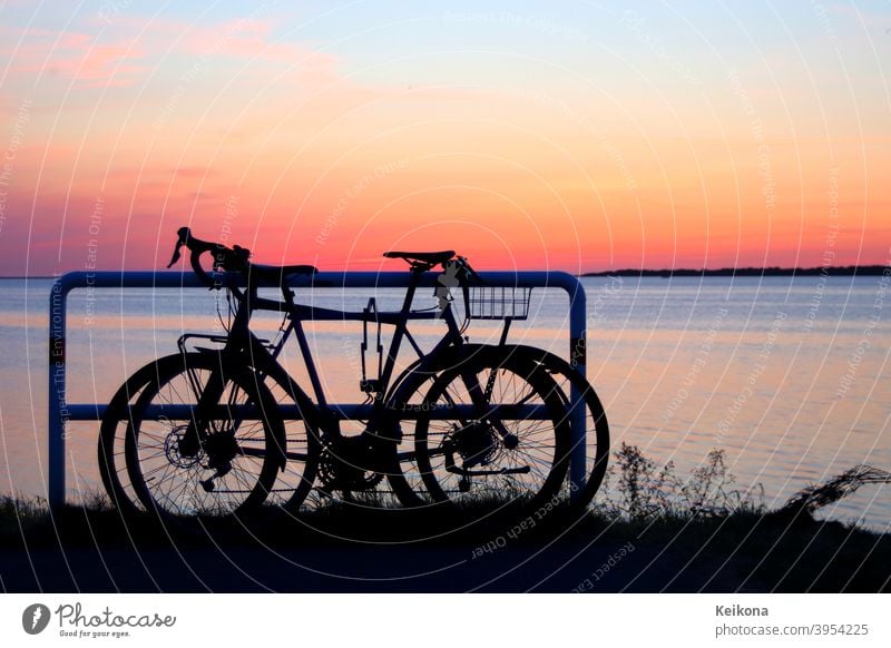 Parked bicycles on sea shore. Sunset environment. active adventure background baltic Baltic Sea bicycling bike biking coast competition Germany europe evening