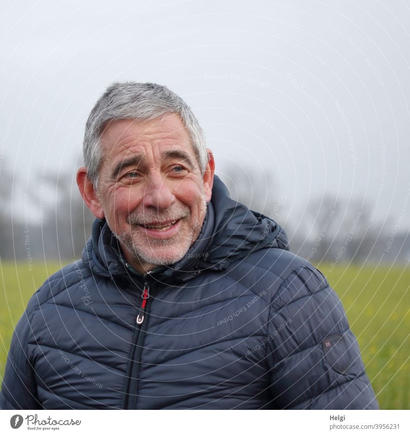Portrait of male senior in blue quilted jacket smiling looking to the side Human being Man Senior citizen 60+ out Winter Jacket Quilted jacket Blue Gray-haired