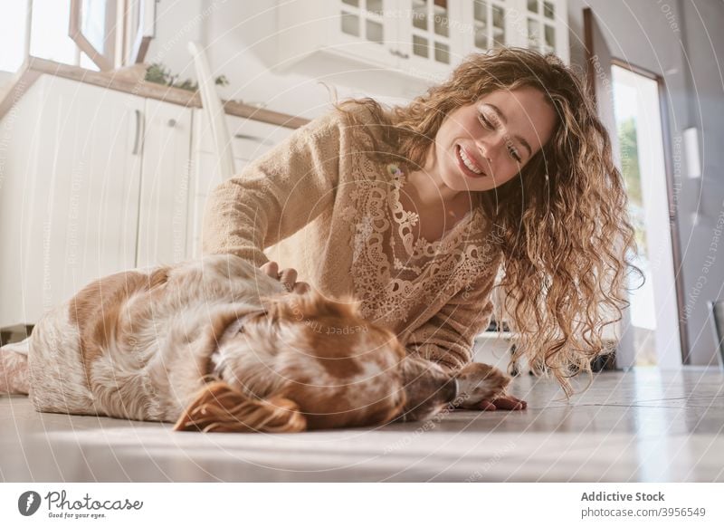 Woman caressing dog at home woman stroke setter animal owner together relax female floor pet happy smile companion canine sit friend domestic obedient