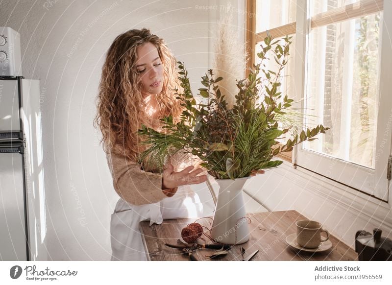 Woman arranging plants in vase bunch woman bouquet fresh gentle flora floristry home female table green style natural harmony decor organic romantic tender