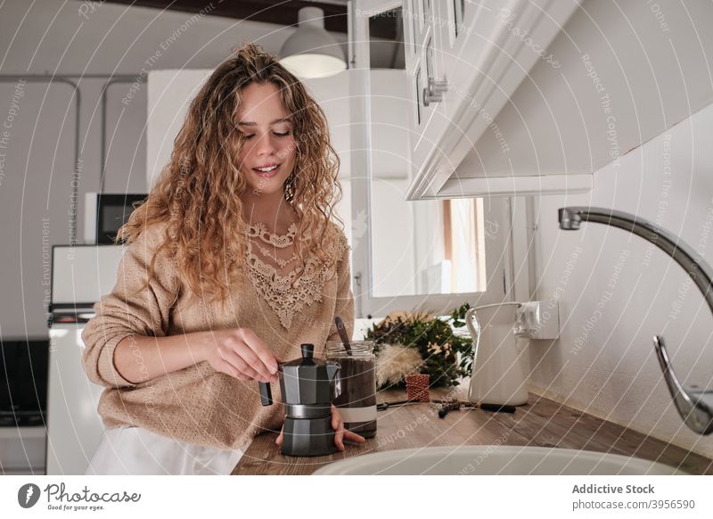 Woman preparing coffee in kitchen woman prepare home breakfast morning white interior counter female modern aromatic fresh young apartment style energy brew