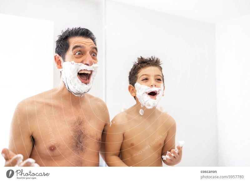 Funny father and son shaving in the bathroom adult bonding boy child childhood cream dad dad and son daddy day elementary face family fatherhood foam fun funny