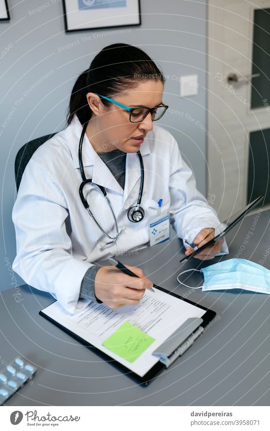 Female doctor doing online consultation with the tablet digital health online medical consultation female working coronavirus telemedicine medtech video call