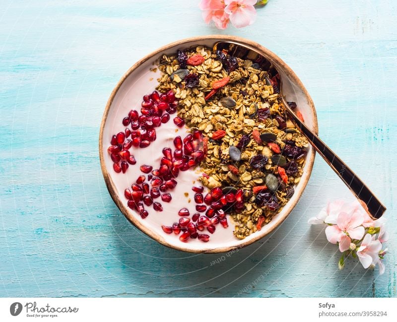 Healthy yogurt bowl with granola and pomegranate healthy berry fruit detox homemade eat top view autumn fall spring flower above breakfast muesli diet food
