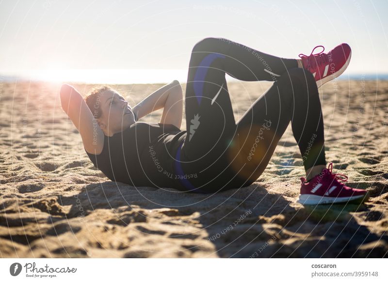 Middle aged woman doing exercise on the beach abs active adult alone athlete attractive balance beautiful blue body energy female fit fitness girl healthy
