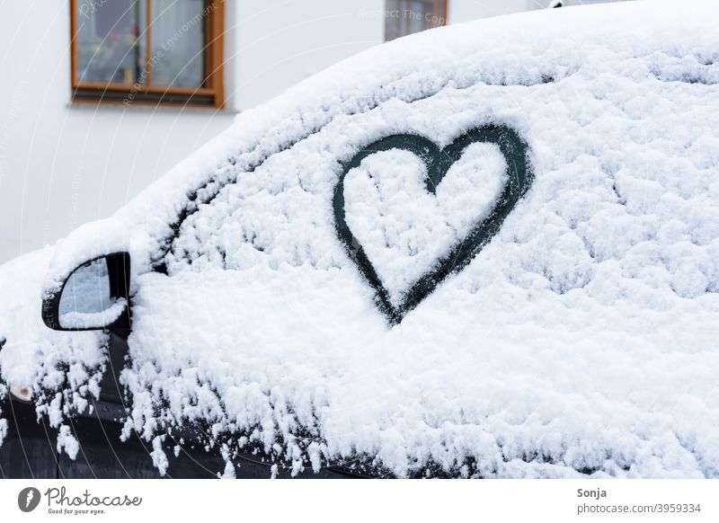 Side window with heart in snow on a black car side window Snow Heart-shaped Frost Exterior shot Winter Cold Ice Frozen Ice crystal Car Parking Black White