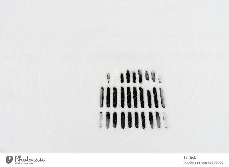 Road drain or gully covered with snow Street gully Snow Gully Intake grille White Snow surface Winter slits Abstract graphically black-white