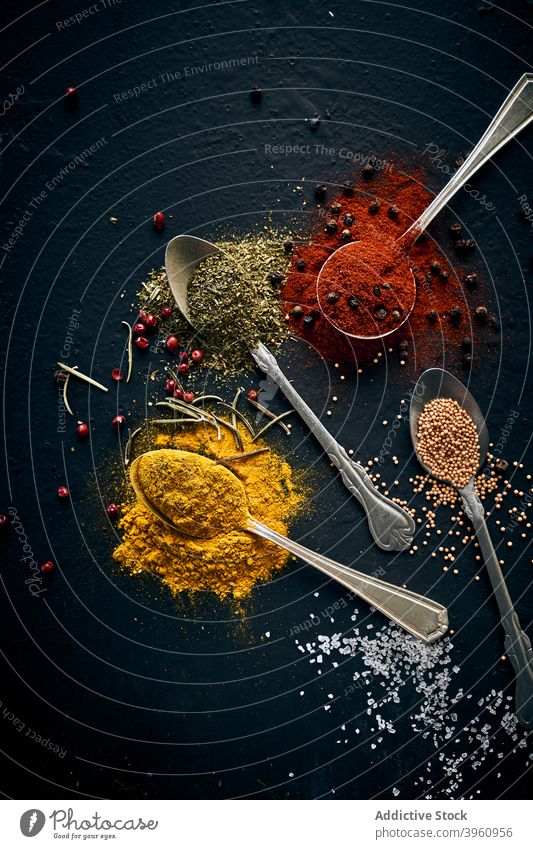 Various spices in spoons on dark table assorted various herb aromatic greenery tasty seasoning condiment fresh culinary organic natural healthy food gourmet