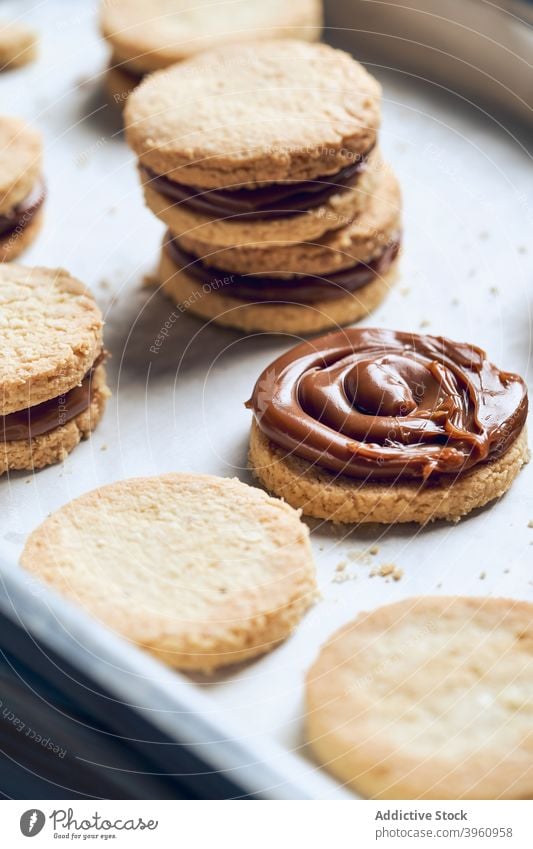 Sandwich cookies with caramel filling sandwich biscuit sweet dessert stuff treat food metal tray cream pastry meal yummy cuisine tasty bakery appetizing baked