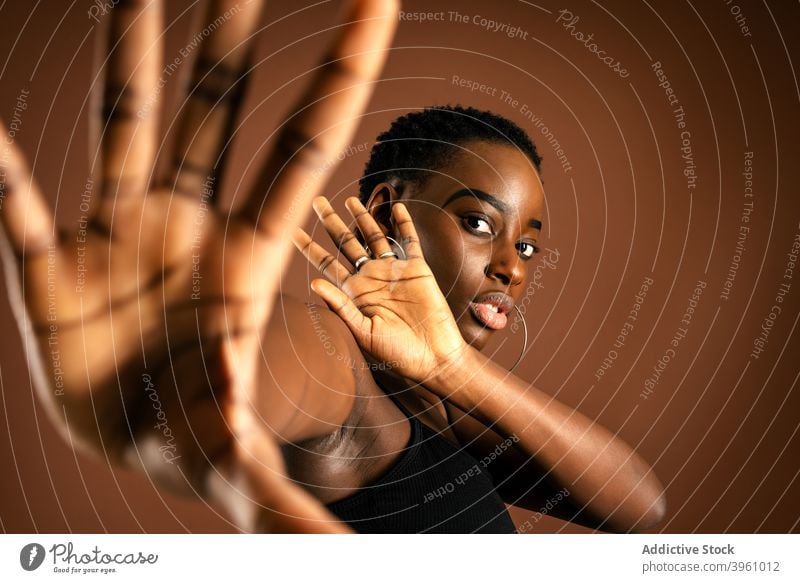 Ethnic woman protecting from camera gesture style stop fashion modern appearance individuality model female young ethnic black refuse african american trendy