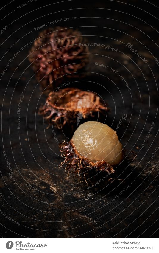 Macro view of rambutan on dark rustic wooden background dessert fruit agriculture asia asian delicious closeup eating exotic food fresh healthy juicy natural