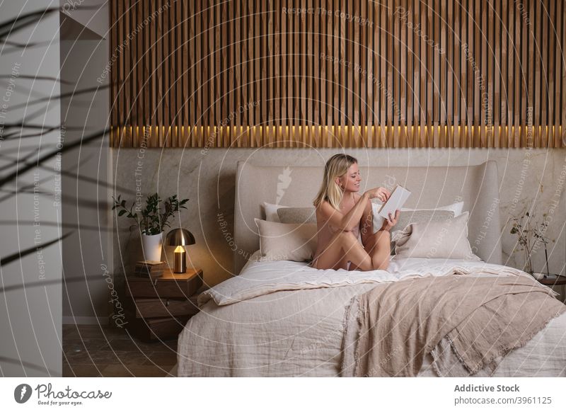 Woman reading book on bed in evening woman enjoy story sleepwear bedroom home female sit interesting novel comfort fiction cozy weekend relax pajama chill lady