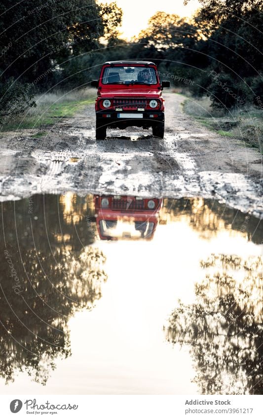 Off road car crossing water puddle in nature off road suv drive man adventure journey travel vehicle lifestyle male forest splash red motion power motor summer