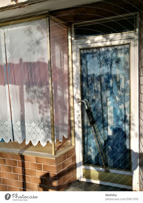 Closed shop with old clinker facade and stuffy curtains and drapes in the sunshine in Lemgo near Detmold in East Westphalia-Lippe drawer business Shop window