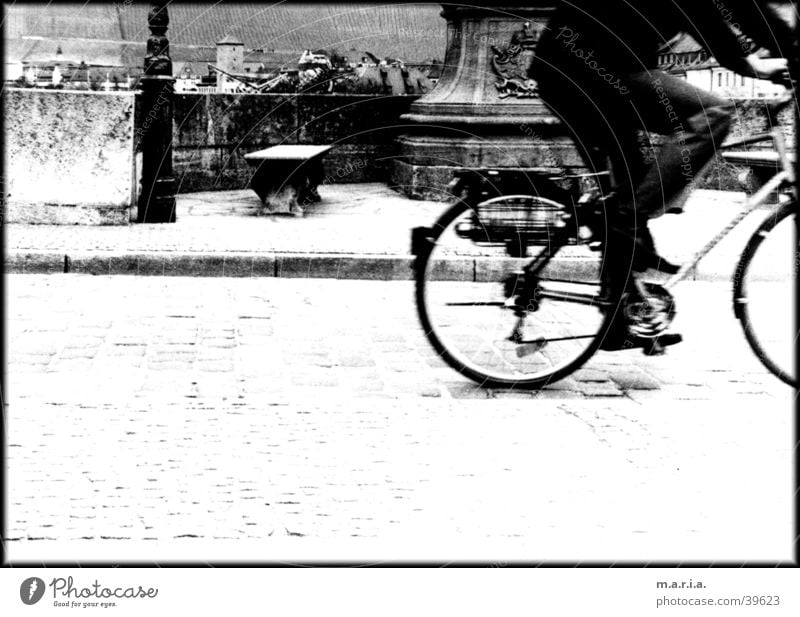 cyclists Bicycle Speed Motion blur Sidewalk Town Würzburg Transport Black & white photo Street Cobblestones Bridge Bench