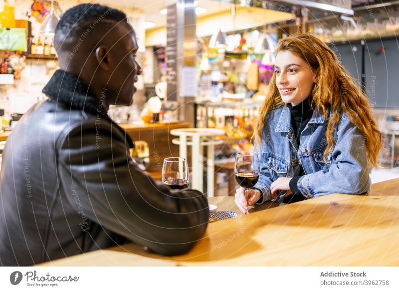 Multiethnic couple drinking wine in cafe date love alcohol romantic relationship together multiethnic multiracial diverse black african american table beverage