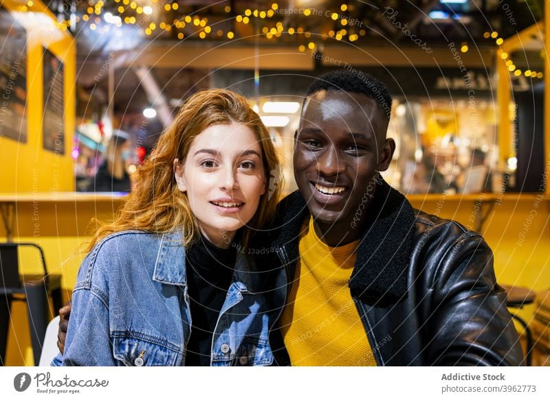 Multiethnic couple relaxing in cafe embrace cheerful together young chill weekend smile relationship multiethnic multiracial diverse black african american