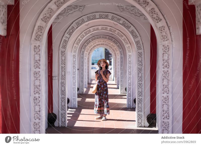 Ethnic woman standing in arched passage of bridge tourist archway traveler destination landmark holiday female ethnic asian cikang overpass taiwan architecture