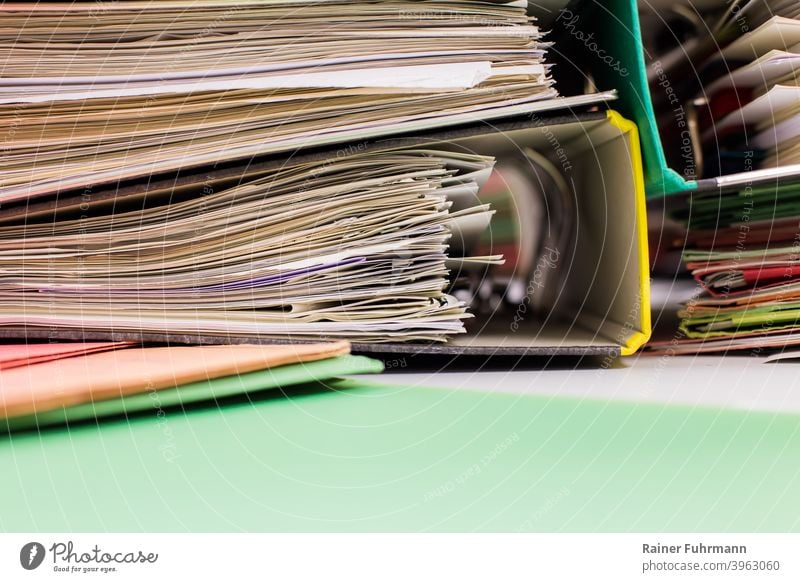 A messy stack of file folders lies on a desk files Office Desk Authority Workplace Work and employment Business Office work Close-up Interior shot Table