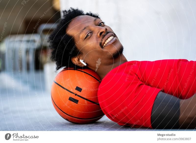 Afro athlete man laying on floor after training. sport basketball urban athletic outdoor standing enjoy expression outdoors active hand exercise recreation