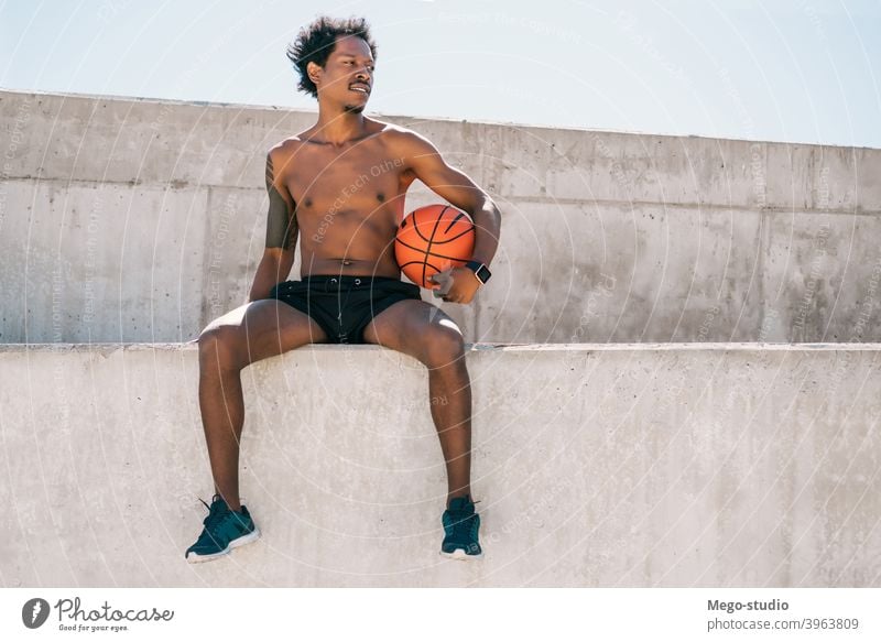 Afro athlete man holding a basketball ball outdoors. sport urban athletic standing enjoy expression active hand exercise recreation sports fitness sportive