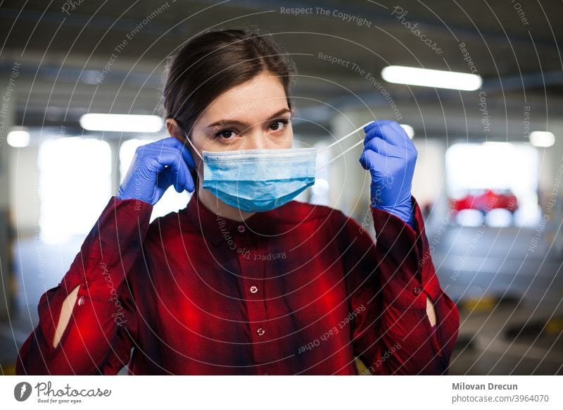 Woman putting mask on adult attractive bacteria blue care caucasian contagious corona coronavirus covid-19 danger disease epidemic equipment face female flu