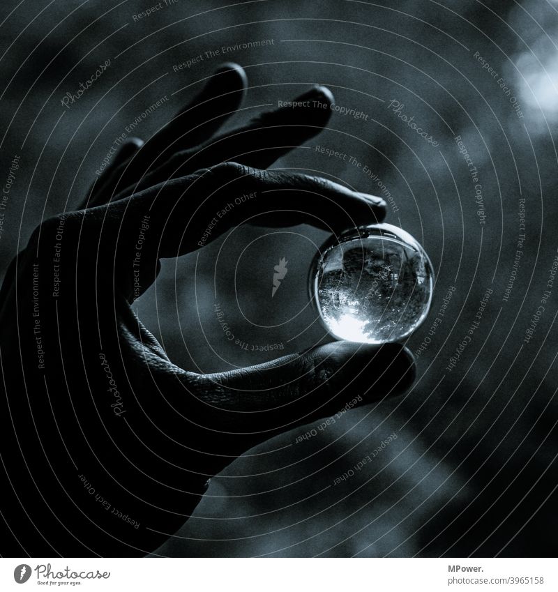 look into the crystal ball Glass ball Hand Round Pane stop Mirror image Black & white photo Reflection Shallow depth of field Light (Natural Phenomenon)