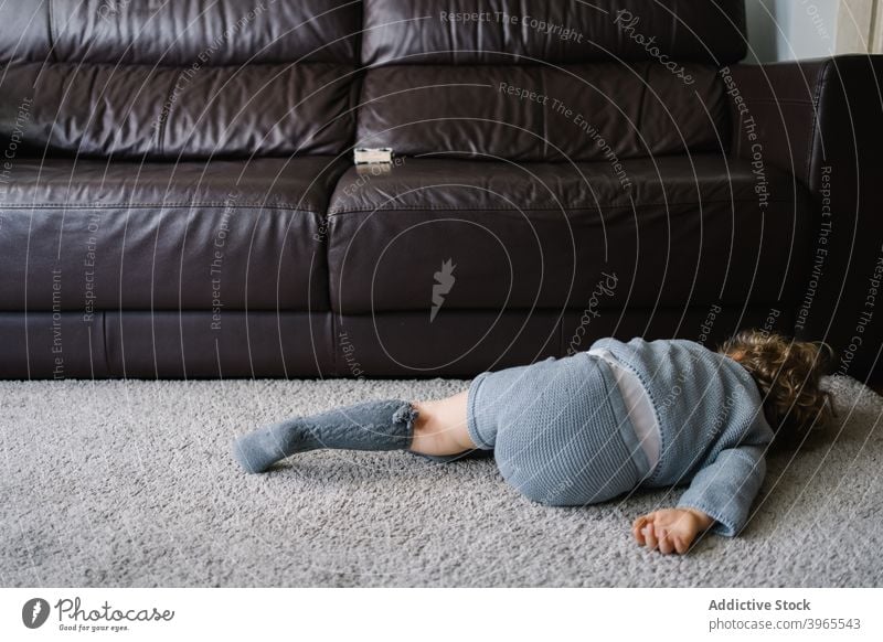 Little kid lying on carpet at home rest little child floor tired relax play lifestyle childhood free time alone tranquil pastime childcare domestic recreation