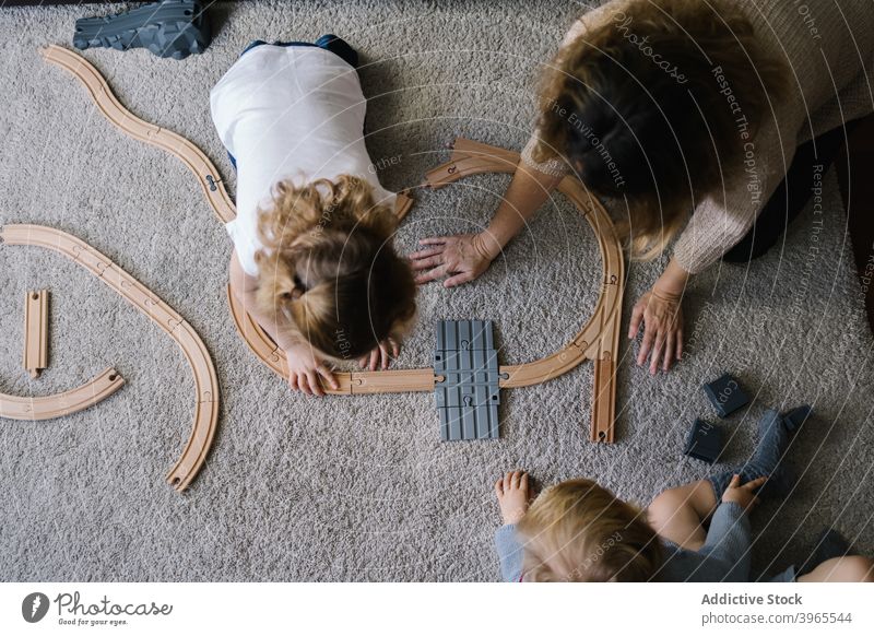 Mother and daughter playing together at home mother assemble toy road kid construct child parent lifestyle love childhood relationship motherhood childcare