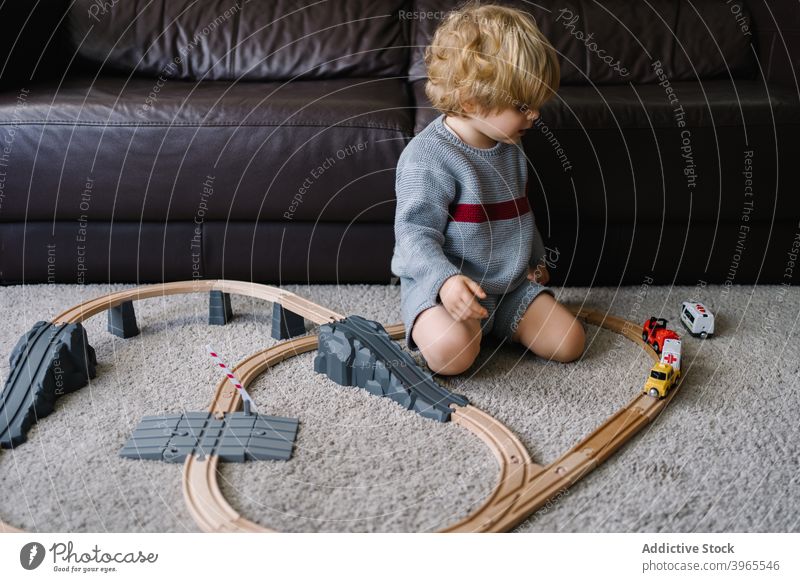 Little boy playing with toy track kid road at home child game activity little childhood lifestyle preschool free time creative childcare construct imagination