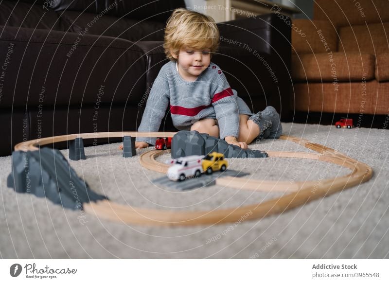 Little boy playing with toy track kid road at home child game activity little childhood lifestyle preschool free time creative childcare construct imagination