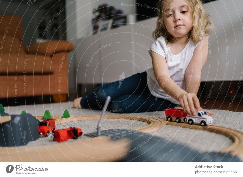 Little girl playing with toy track road at home child game activity little childhood lifestyle preschool free time creative childcare construct imagination