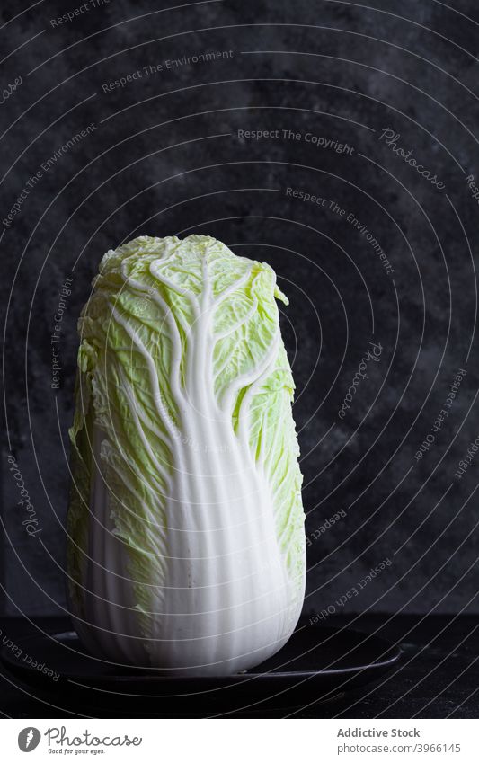 Fresh Chinese cabbage on plate on table chinese cabbage vegetable oriental fresh green ripe studio vegetarian food healthy organic cuisine gastronomy vitamin