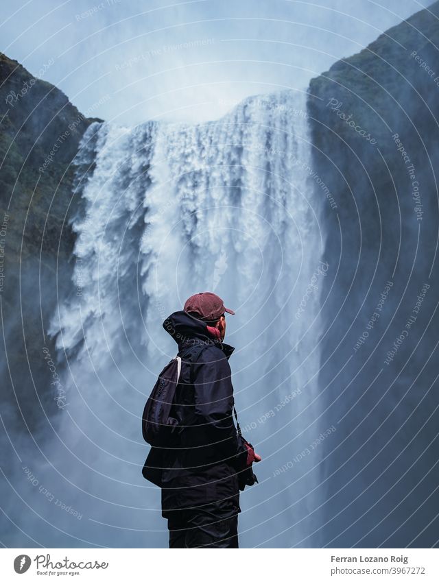 Portrait of a man looking a waterfall Waterfall Iceland Portrait photograph portrait Young man Cold Blue Nature Mountain Paradise