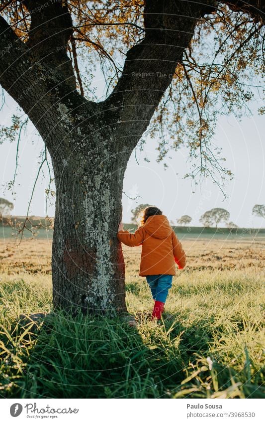 Rear view child near a tree Child Unrecognizable Playing Girl Nature Happiness Colour photo Day Human being Cute Lifestyle Leisure and hobbies Toddler Happy Joy